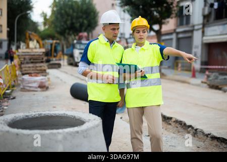 Two qualified engineers are discussing a construction plan Stock Photo