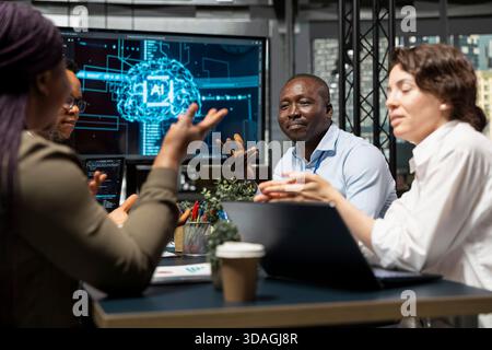 Admins doing brainstorming, developing AI software in startup office, designing coding solutions together. IT coworkers optimizing technical performance using artificial intelligence during meeting Stock Photo