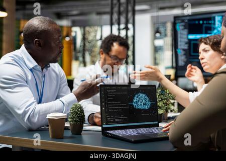 Startup coworkers discussing machine learning tech roadmap during briefing session. Computer scientists developing AI applications in office, analyzing system performance metrics after QA testing Stock Photo