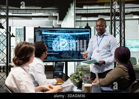 Manager and IT employees collaborate on implementation of AI solutions to increase productivity in business sector. Team leader and engineers discussing software development roadmap in startup office Stock Photo
