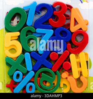 Bright and colorful plastic numbers and alphabet letters designed for kids, arranged playfully to encourage early learning and creativity. The smooth Stock Photo