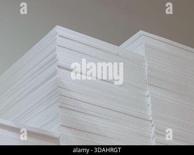 Large stack of clean white paper sheets piled high in an office. close up, low angle view showing textured background of business documents for paperw Stock Photo