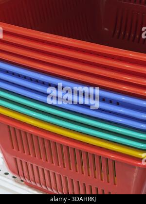 Vibrant, colorful abstract background showing stack of plastic baskets in red, blue, green, and yellow. geometric pattern creates pleasing and organiz Stock Photo