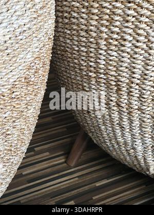 Close up detail of natural woven wicker chair texture for background. This rustic, handmade furniture with braided pattern creates warm, cozy and comf Stock Photo