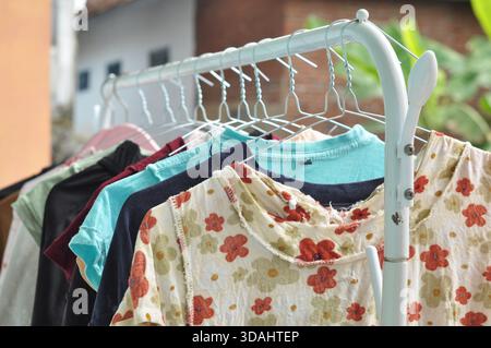 Colorful Clothes Hanging on Outdoor Drying Rack in Natural Light Stock Photo