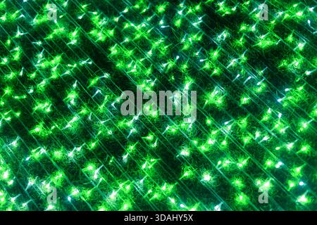 Mesmerizing abstract green background with vibrant sparkle pattern. glittering, glowing texture with futuristic, magical effect creates dazzling light Stock Photo