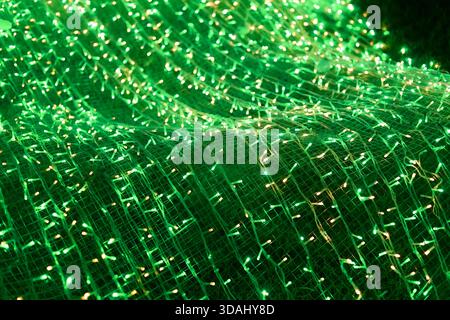 Vibrant, abstract background of glowing green light creates dynamic, energetic pattern. futuristic, illuminated texture gives magical, festive and tec Stock Photo