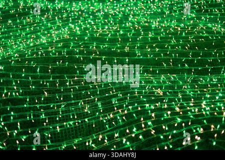 Mesmerizing green abstract background of glowing technology light. This vibrant futuristic network grid creates digital pattern, an energetic concept Stock Photo