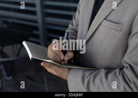 Close-up of a businessman working on a tablet, focused and serious Stock Photo