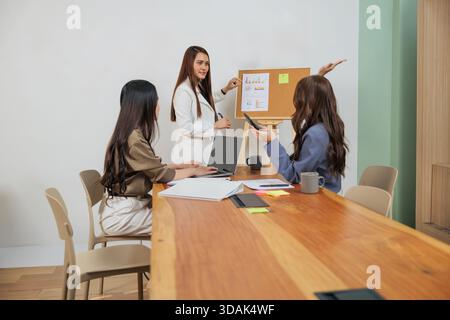 Busy office work people meet market team women collaborating on business strategy, presenting data Stock Photo
