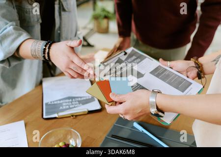 Young Adult Women and Men Collaborating on Interior Design Project Stock Photo