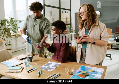 Young Multiethnic Coworkers Collaborating on Project in Modern Office Stock Photo