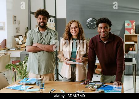 Multiethnic Young Adults Collaborating during Creative Office Meeting Stock Photo