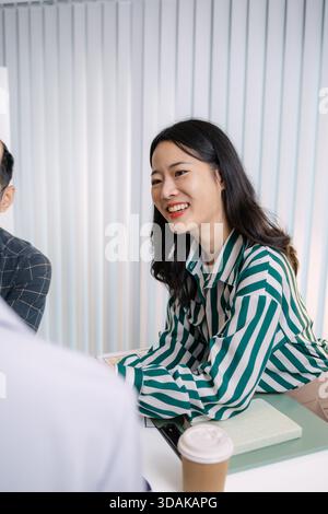 A group of UX/UI designers brainstorming creative ideas together, discussing color palettes and layout concepts for a new mobile application interface Stock Photo