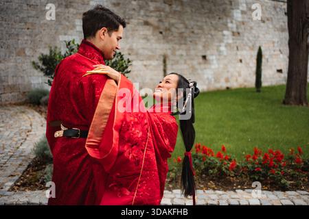 Intercultural couple celebrating wedding in traditional Chinese clothing Stock Photo