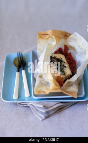 Cod in parchment paper Stock Photo