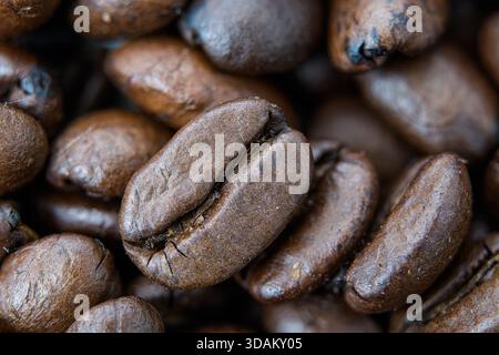 Macro close-up of roasted coffee beans with rich brown texture. Stock Photo