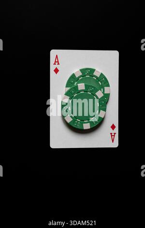 Stack of green casino chips against green background Stock Photo - Alamy