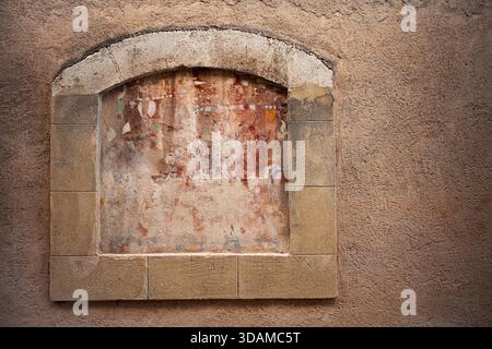 Boarded-up window in a plastered wall Stock Photo