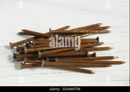 Old rusty nails on wooden background Stock Photo