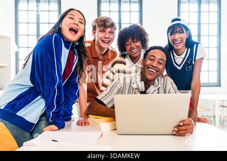 Multiethnic group of young students meeting at the library - diverse group of young students smiling and laughing, enjoying a moment together while lo Stock Photo