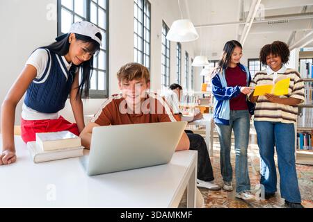 Multiethnic group of young students meeting at the library - diverse group of young students engaging in collaborative study within a modern library, Stock Photo