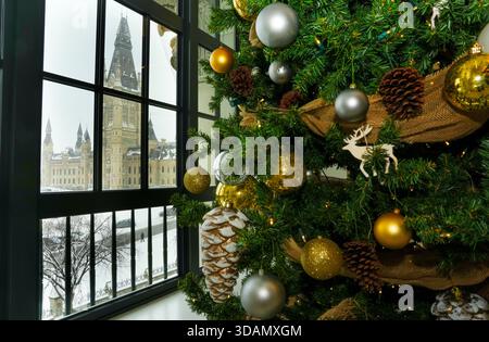 Ottawa, Canada. 11th Dec, 2025. The Mackenzie Tower of West Block on Parliament Hill is pictured through a window of the Wellington Building as Christmas holiday season decorations adorn the lobby in Ottawa on Thursday, Dec. 11, 2025. Credit: The Canadian Press/Ģ����ý Live News Stock Photo