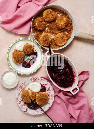 Traditional Austrian cottage cheese dumplings in breadcrumbs with plum compote and sour cream.top veiw.style hugge.selective focus Stock Photo