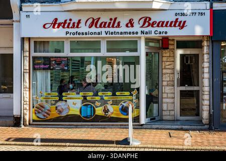 Exterior storefront of a  Vietnamese nail care salon on a UK high street in Weymouth, England. Concept - Urban change, Migration, Business competition Stock Photo