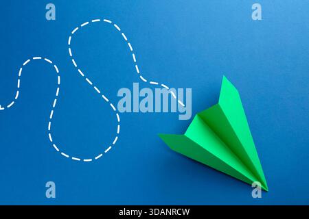 Paper plane with dotted line as air route track on blue background Stock Photo