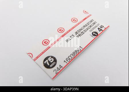Clean macro shot of a Warsaw public transport transfer ticket placed on a white surface. Stock Photo