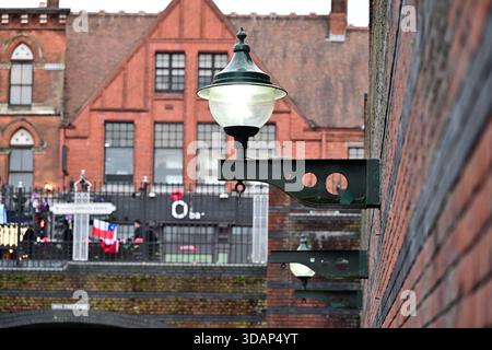 Vintage Street Lamps on Brick Wall beside Historic Building Stock Photo