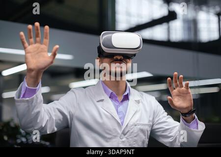 Man Wearing Virtual Reality Headset in Modern Office Environment During Work Hours Stock Photo