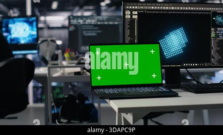 Close up of mockup laptop in server room where worker uses AI to review diagnostics. Admin in data center analyzing performance data using artificial intelligence on isolated screen notebook, camera A Stock Photo