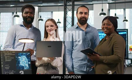 Team of programmers in office automating repetitive tasks using AI scripts on devices. Teamworking IT experts brainstorming, using artificial intelligence to speed up feature implementation, camera A Stock Photo