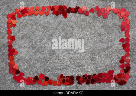 Simple frame made from many red heart confetti pieces Stock Photo