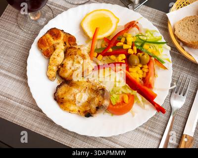 Oven baked hake with vegetable garnish Stock Photo