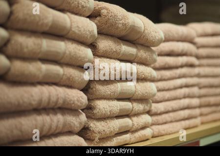 Soft towels arranged neatly on a shelf in a store Stock Photo
