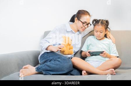 Device technology family online education concept. Happy family with digital devices at home. Family Activities Concept. Stock Photo