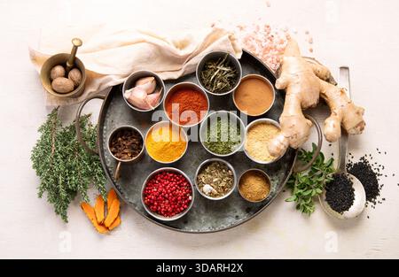 Many different spices. A collection of various spices and herbs on a light background. Top view. Stock Photo