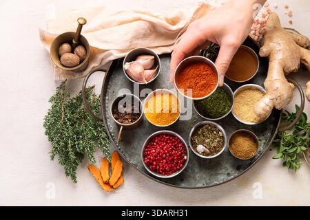 Many different spices. A collection of various spices and herbs on a light background. Top view. Stock Photo