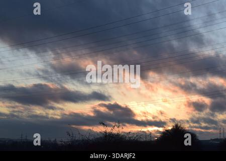 sunset light in heavy dark clouds Stock Photo
