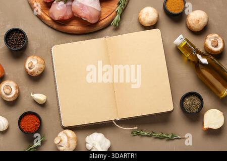 Composition with blank open recipe book and ingredients on color background Stock Photo