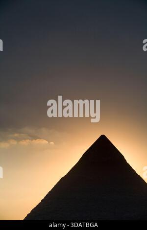 Silhouette of the Giza pyramid at sunset against a blood-red sky, Egypt ...