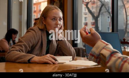 Young woman talking and gesturing, engaged in a lively conversation Stock Photo
