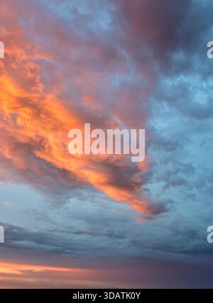 Serene, captivating sky only view at sunset. Dramatic, colorful light spectacle, creating a feeling of peace, calm, and wonder in the atmosphere. Stock Photo