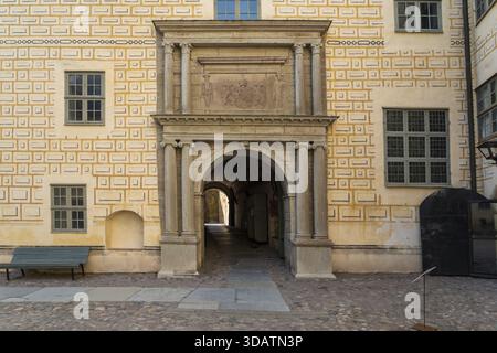 View of an arched stone entrance of Kalmar Castle, framed by decorative brickwork and classical columns, leads into a shadowed passageway, Kalmar, Kal Stock Photo