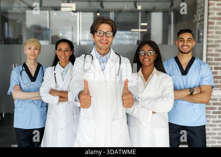 Multiethnic team of doctors posing together, smiling at camera Stock Photo