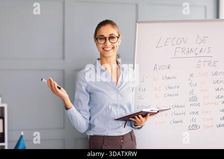 French Language Lesson Conducted by a Smiling Teacher in a Classroom Setting Stock Photo