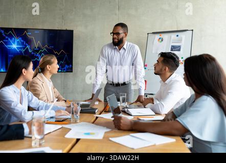 Corporate Meeting With Diverse Business Professionals Discussing Strategy in Modern Office Setting Stock Photo